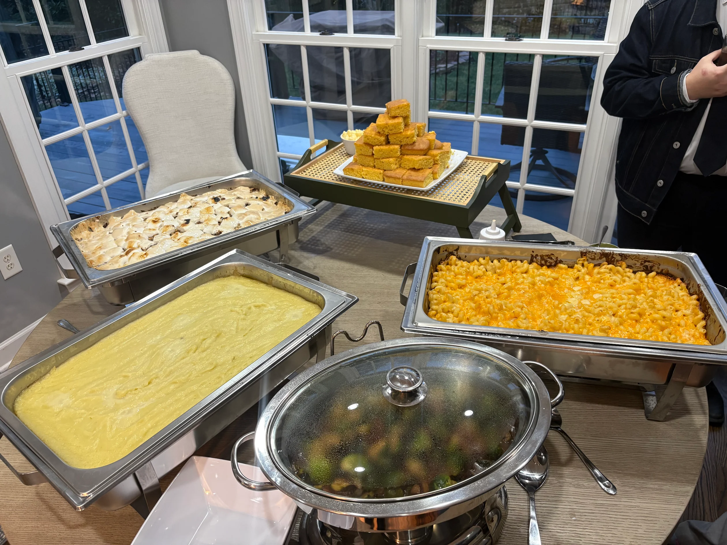 Catering buffet with macaroni and cheese, cornbread, and seasonal vegetables