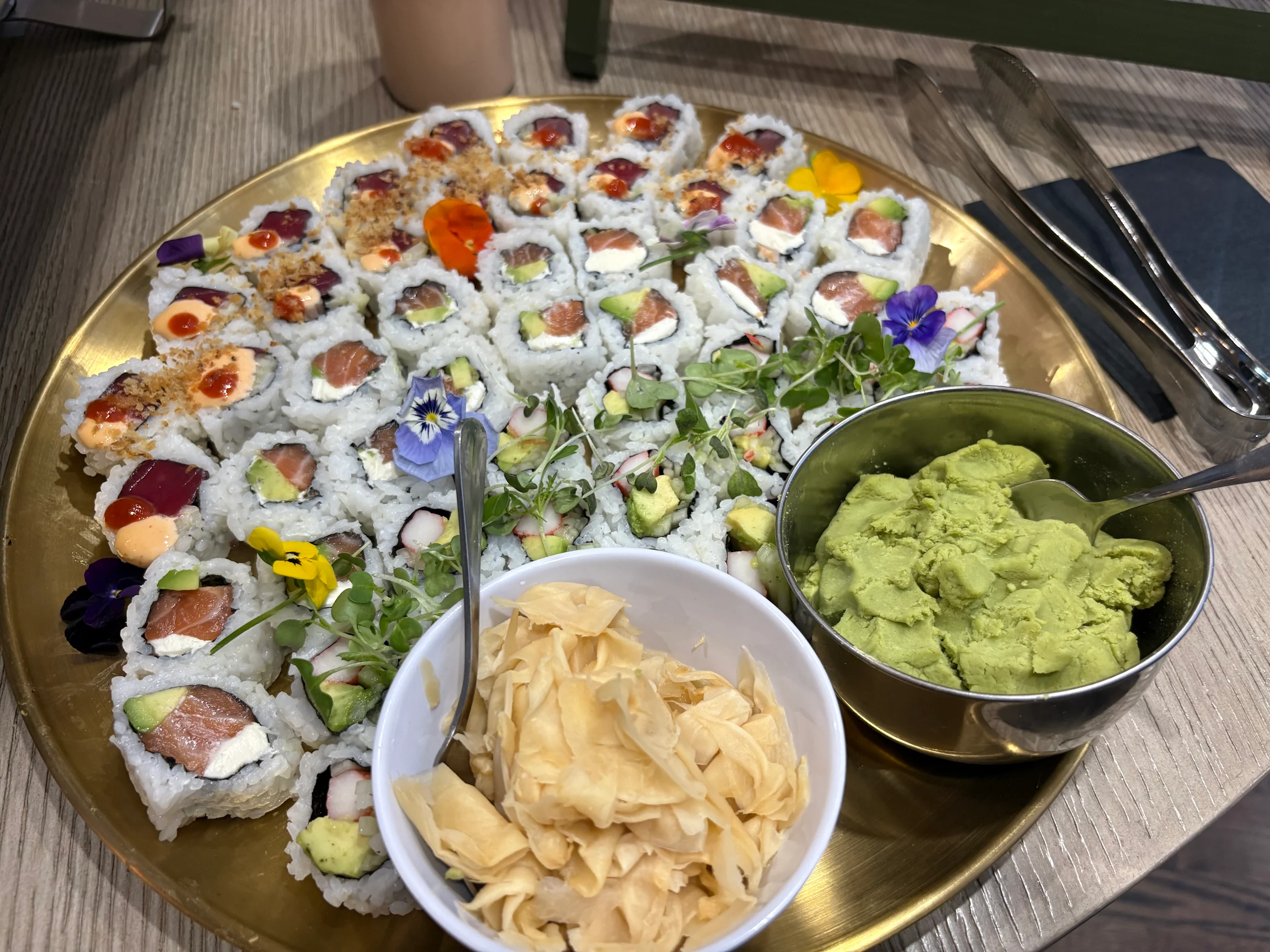 At-home sushi making experience platter with assorted rolls and edible flowers in Virginia Beach, VA